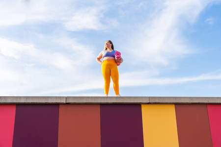 Beautiful and cheerful plus size young woman outdoors - Pretty overweight curvy female, concepts about femininity, women power, female emancipation, body positivity and body acceptanceの写真素材