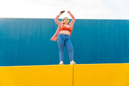 Beautiful and cheerful plus size young woman outdoors - Pretty overweight curvy female, concepts about femininity, women power, female emancipation, body positivity and body acceptanceの写真素材