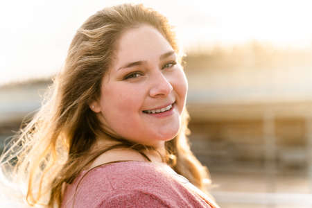 Beautiful and cheerful plus size young woman outdoors - Pretty overweight curvy female, concepts about femininity, women power, female emancipation, body positivity and body acceptanceの写真素材