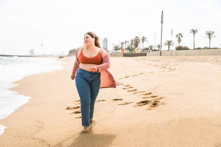 Beautiful and cheerful plus size young woman outdoors - Pretty overweight curvy female, concepts about femininity, women power, female emancipation, body positivity and body acceptanceの写真素材