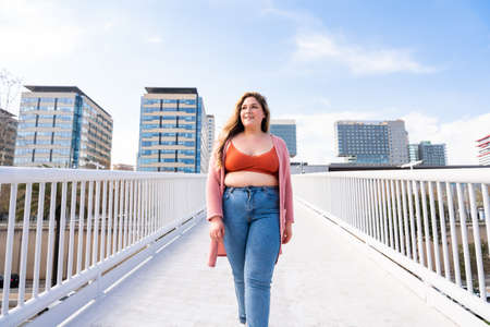 Beautiful and cheerful plus size young woman outdoors - Pretty overweight curvy female, concepts about femininity, women power, female emancipation, body positivity and body acceptanceの写真素材