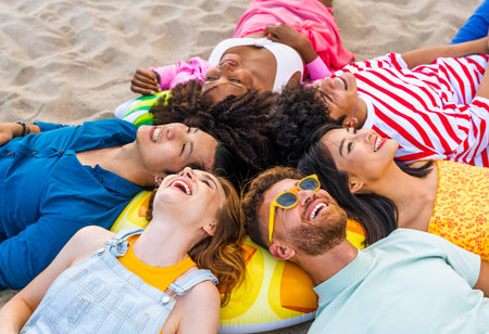 Multiethnic group of young happy friends bonding outside, having fun on summertime vacation - Multicultural cheerful people with summer clothes enjoying summer holidays, concepts about youth, friendship and positive emotionの写真素材