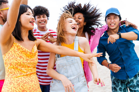 Multiethnic group of young happy friends bonding outside, having fun on summertime vacation -...