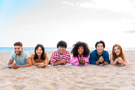 Multiethnic group of young happy friends bonding outside, having fun on summertime vacation - Multicultural cheerful people with summer clothes enjoying summer holidays, concepts about youth, friendship and positive emotionの写真素材