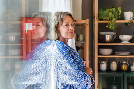 Beautiful mature senior woman at home, domestic life and leisure moments - 50-60 years old pretty...