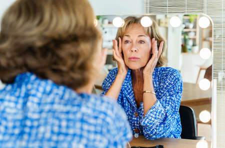 Beautiful mature senior woman at home, domestic life and leisure moments - 50-60 years old pretty female adultの写真素材