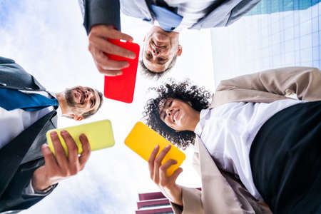 Multiracial group of business people bonding outdoors - International business corporate team...