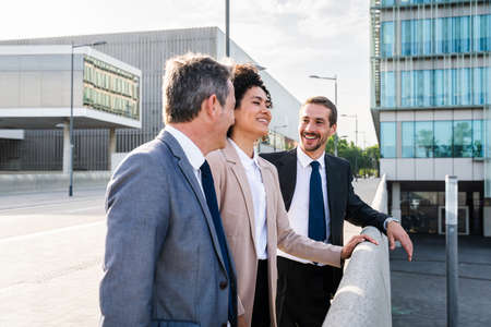 Multiracial group of business people bonding outdoors - International business corporate team...