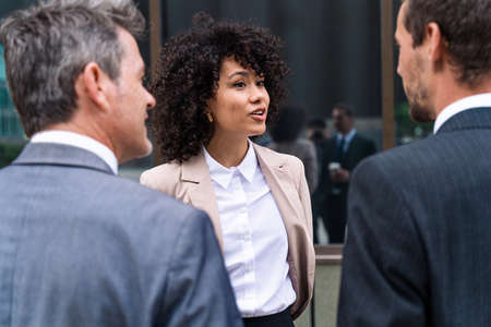 Multiracial group of business people bonding outdoors - International business corporate team...