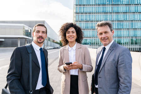 Multiracial group of business people bonding outdoors - International business corporate team...