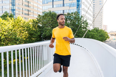 Black hispanic sportsman training outdoors in the city - African man with fit muscular body doing functional workout to train cardio, body muscles and abs coreの写真素材