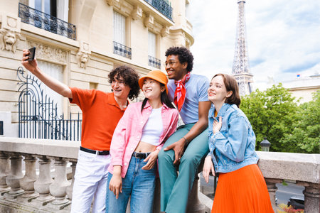 Group of young happy friends visiting Paris and Eiffel Tower, Trocadero area and Seine river - Multicultural group of tourists sightseeing the France capital cityの写真素材