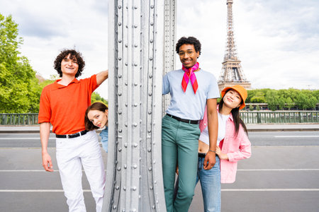 Group of young happy friends visiting Paris and Eiffel Tower, Trocadero area and Seine river - Multicultural group of tourists sightseeing the France capital cityの写真素材