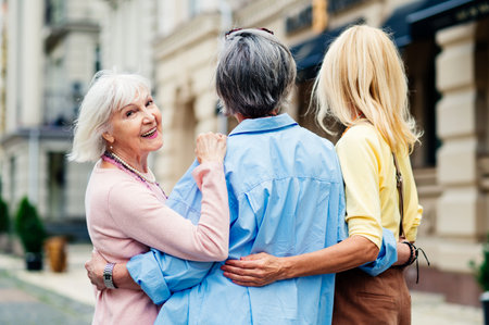 Beautiful happy senior women meeting outdoors and shopping in the city center - Pretty and joyful old female adult people bonding and having fun outdoorsの写真素材