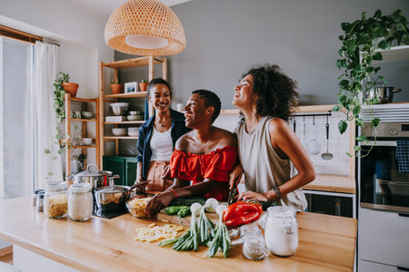 Happy beautiful hispanic south american and black women meeting indoors and having fun - Black adult females best friends spending time together, concepts about domestic life, leisure, friendship and togethernessの写真素材