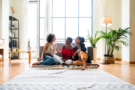 Happy beautiful hispanic south american and black women meeting indoors and having fun - Black adult females best friends spending time together, concepts about domestic life, leisure, friendship and togethernessの写真素材