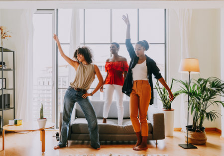 Happy beautiful hispanic south american and black women meeting indoors and having fun - Black adult females best friends spending time together, concepts about domestic life, leisure, friendship and togethernessの写真素材