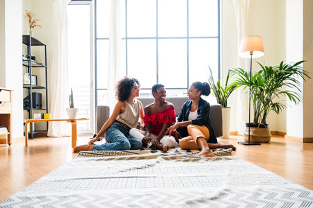 Happy beautiful hispanic south american and black women meeting indoors and having fun - Black adult females best friends spending time together, concepts about domestic life, leisure, friendship and togethernessの写真素材