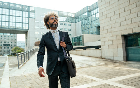 Young entrepreneur business man walking outside his office after a busy day of successful workの写真素材
