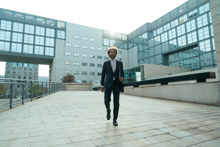 Young entrepreneur business man walking outside his office after a busy day of successful workの写真素材