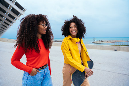 young happy women having fun outdoor , laughing and sharing good mood. Teenagers girls walking at the harbor in Barcelona after schoolの写真素材