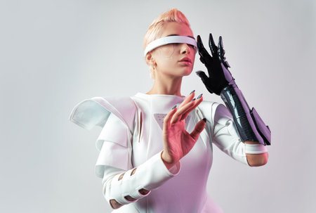 Representation of a bionic super human with advanced technology parts as vr visors and gadgets playing in a mixed reality training room. Futuristic cyberpunk evolution of human mankind and AIの写真素材