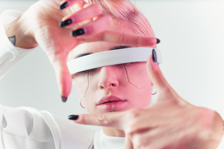 Representation of a bionic super human with advanced technology parts as vr visors and gadgets playing in a mixed reality training room. Futuristic cyberpunk evolution of human mankind and AIの写真素材