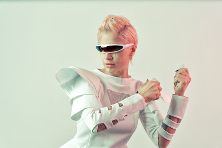 Representation of a bionic super human with advanced technology parts as vr visors and gadgets playing in a mixed reality training room. Futuristic cyberpunk evolution of human mankind and AIの写真素材