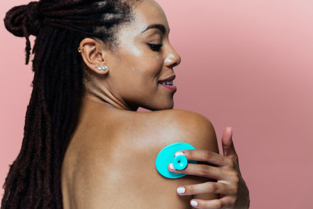 Beautiful woman making skin and facial beauty treatments. Studio shot with focus on cosmetic and skin care conceptsの写真素材