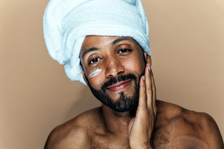 Image of a young man taking care of his skin. Beauty studio shot about skin care and products for the personal hygiene.の写真素材
