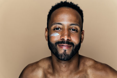 Image of a young man taking care of his skin. Beauty studio shot about skin care and products for the personal hygiene.の素材 [FY310196116068]