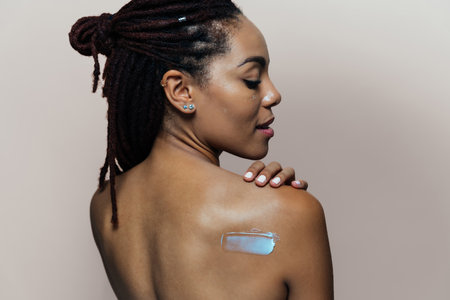 Beautiful woman making skin and facial beauty treatments. Studio shot with focus on cosmetic and...