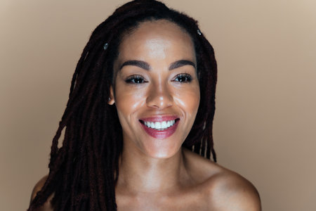 Beautiful woman making skin and facial beauty treatments. Studio shot with focus on cosmetic and...
