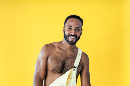 Image of a handsome young man posing on colored backgrounds wearing colorful trendy clothes. Concept about carefree, fashion and lifestyleの写真素材