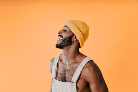 Image of a handsome young man posing on colored backgrounds wearing colorful trendy clothes. Concept about carefree, fashion and lifestyleの写真素材