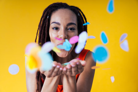 Image of a beautiful young woman posing on colored backgrounds wearing colorful trendy clothes....
