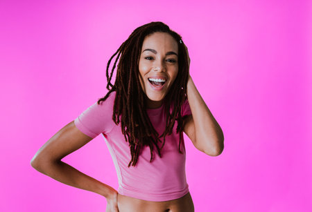Image of a beautiful young woman posing on colored backgrounds wearing colorful trendy clothes....