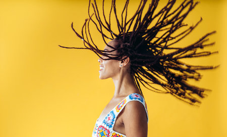 Image of a beautiful young woman posing on colored backgrounds wearing colorful trendy clothes. Concept about carefree, fashion and lifestyleの写真素材