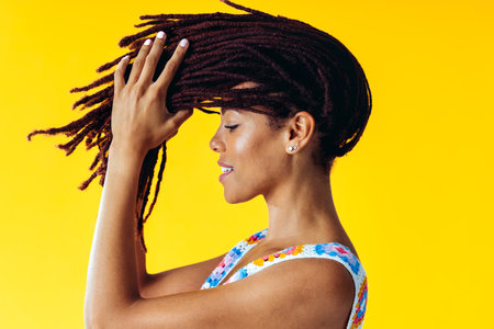 Image of a beautiful young woman posing on colored backgrounds wearing colorful trendy clothes....
