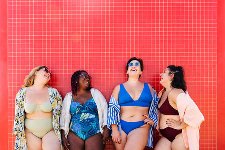 Group of beautiful plus size women with swimwear bonding and having fun at the beach - Group of curvy female friends enjoying summertime at the sea, concepts about body acceptance, body positive and self confidenceの写真素材