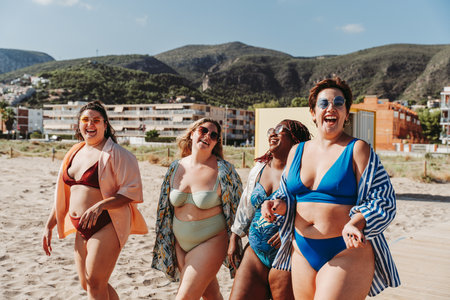 Group of beautiful plus size women with swimwear bonding and having fun at the beach - Group of curvy female friends enjoying summertime at the sea, concepts about body acceptance, body positive and self confidenceの写真素材