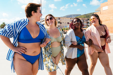 Group of beautiful plus size women with swimwear bonding and having fun at the beach - Group of curvy female friends enjoying summertime at the sea, concepts about body acceptance, body positive and self confidenceの写真素材