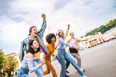 Multiracial young people together meeting and social gathering - Group of friends with mixed races having fun outdoors in the city- Friendship and lifestyle conceptsの写真素材