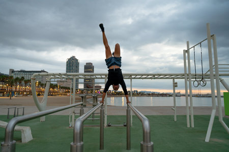 Sportive and athletic man doing functional training exercise at the outdoor gym - Adult athlete...