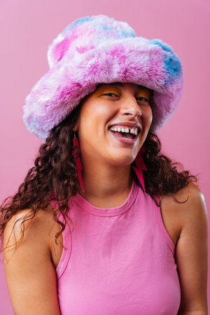 Beautiful young hispanic woman with diastema with colorful and cool style - Confident and interesting female with diverse and unique style, concepts about fashion, individuality and body acceptanceの写真素材