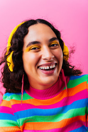 Beautiful young hispanic woman with diastema with colorful and cool style - Confident and interesting female with diverse and unique style, concepts about fashion, individuality and body acceptanceの写真素材