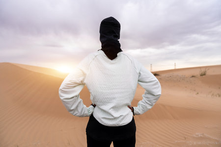 Beautiful middle-eastern arab woman wearing hijab training outdoors in a desert area - Sportive athletic muslim adult female wearing burkini sportswear doing fitness workoutの写真素材