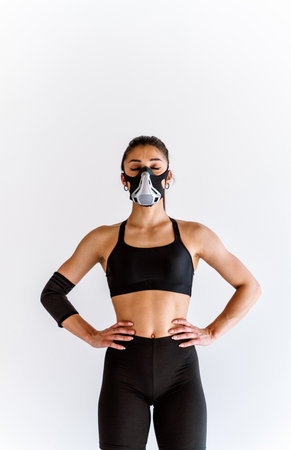 Young female athlete training in a gym using sport equipment. Fit woman working out. Concept about fitness, wellness and sport preparation.の写真素材