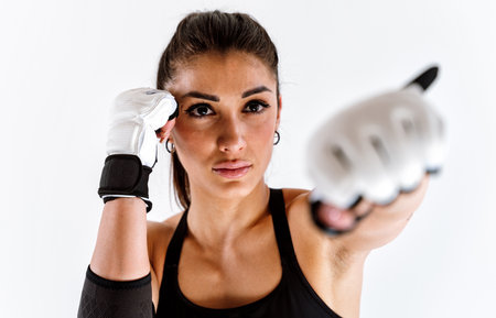 Young female athlete training in a gym using sport equipment. Fit woman working out. Concept about...