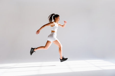 Young female athlete training in a gym using sport equipment. Fit woman working out. Concept about fitness, wellness and sport preparation.の写真素材